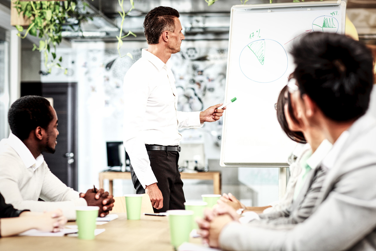 Businessman in Meeting with Chart